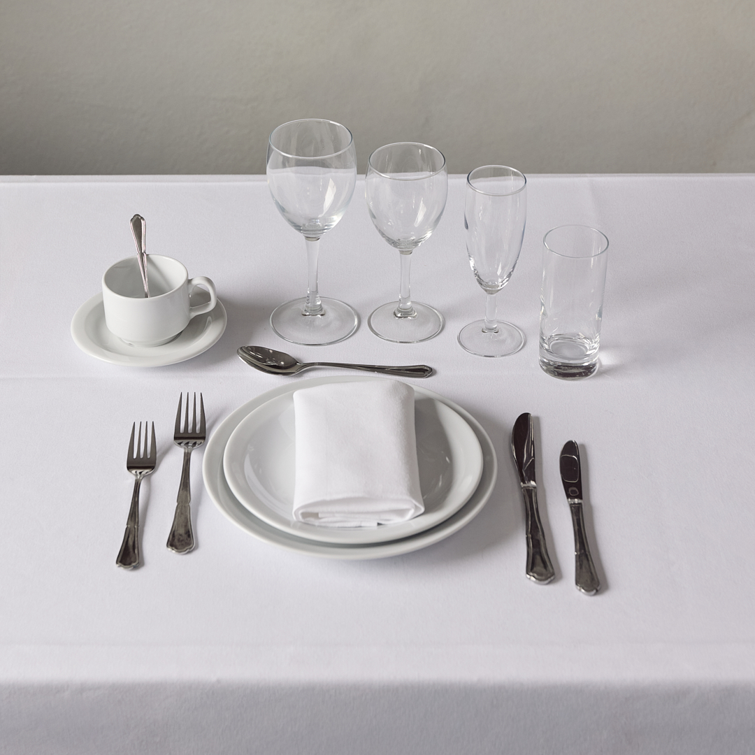 Eight shirts arranged on table in black, olive, grey, blue, white, red, mustard, and green.